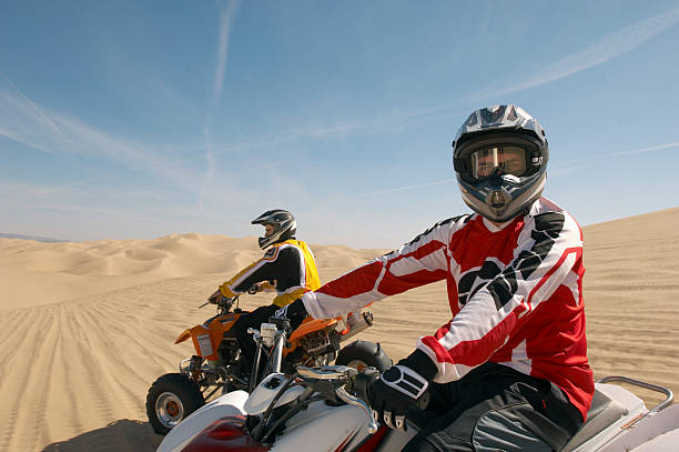 istock Man Riding Quadbike In Desert 521071789
