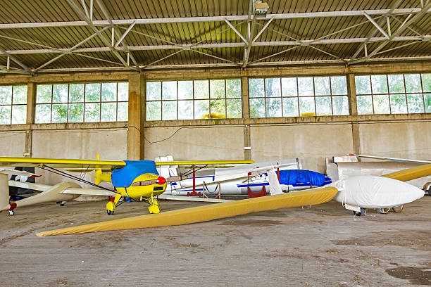 istock Lightweight gliders stationed inside of a big hangar 521072295