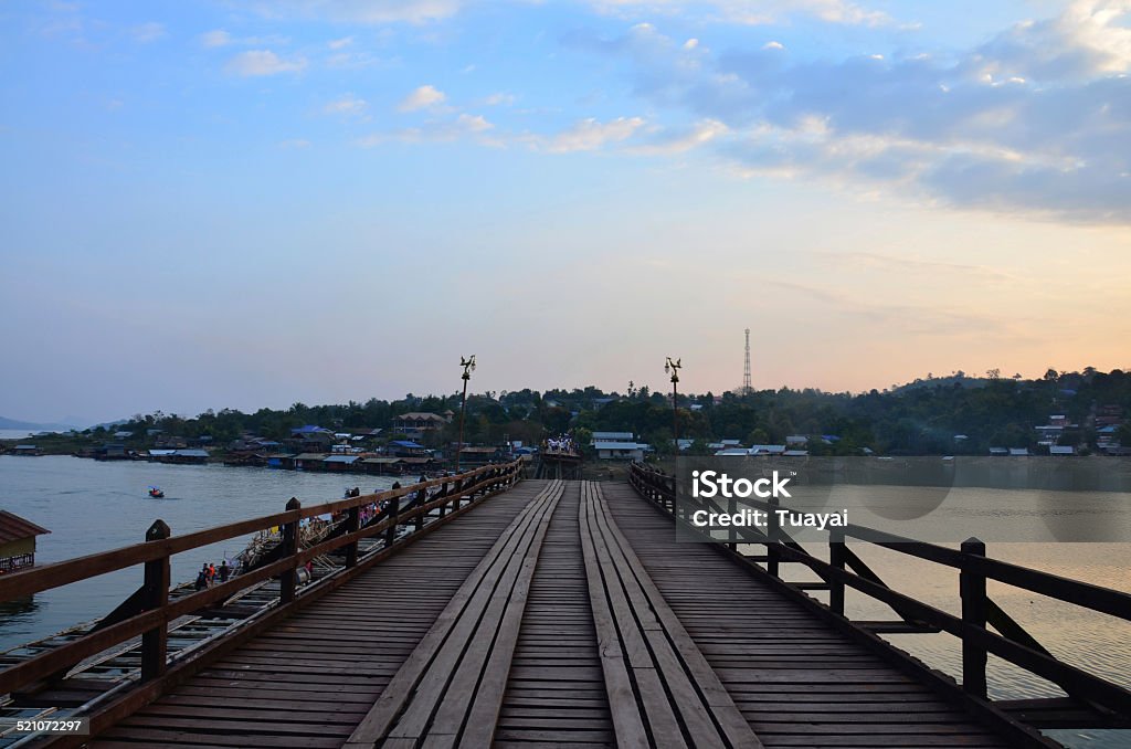 Saphan Mon at sunset time Today, ThailandTravel  bring you guys back into the past with one of the attractions in Thailand. Focus on the Kanchanaburi Province, Sangkhlaburi District, this attraction is called “Wooden Mon Bridge” that you guys can pronounce in Thai language “Saphan Mon”. Architecture Stock Photo