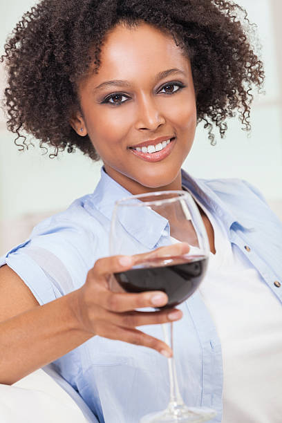 istock Mixed Race African American Girl Drinking Red Wine 521073979