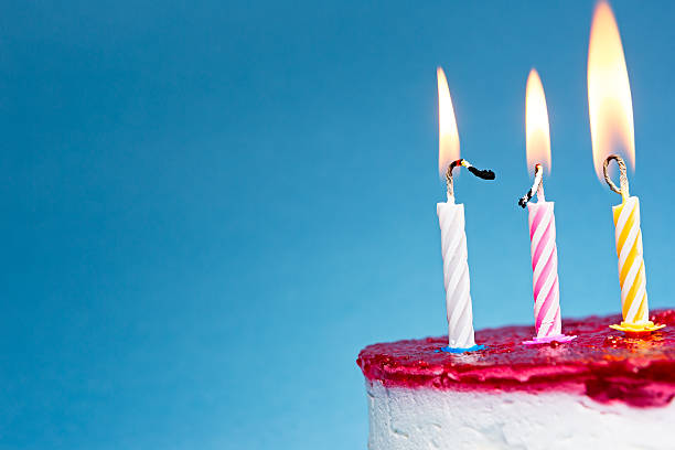 istock Flaming Birthday Candles on blue background 521074797