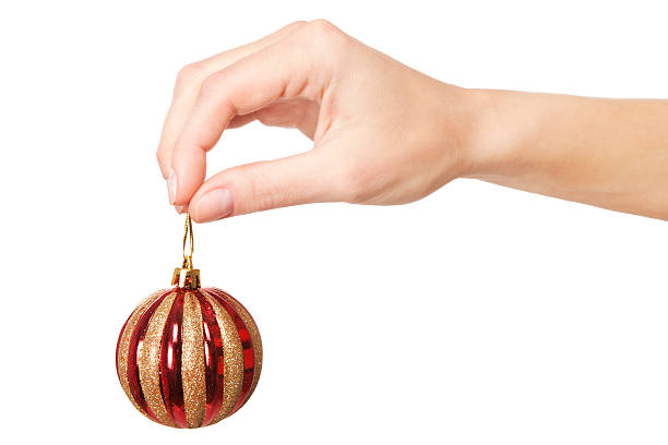 istock Woman's hand holding a Christmas ball 521075057