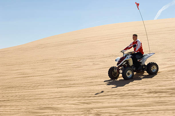 istock Man Riding Quad Bike In Desert 521075495