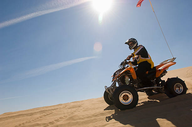 istock Man Riding Quadbike In Desert 521075505