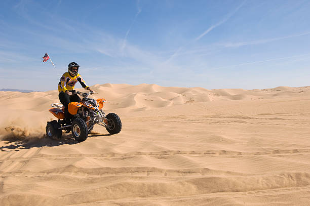 istock Man Riding Quadbike In Desert 521075515