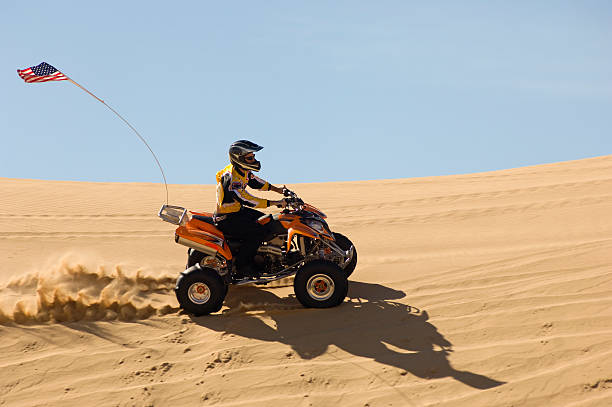 istock Man Riding Quadbike In Desert 521075537