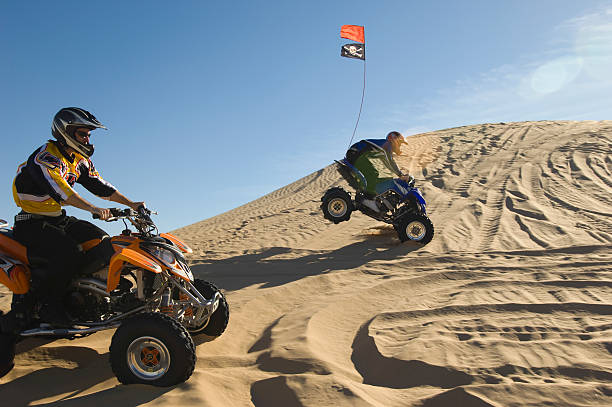 istock Men Riding Quad Bikes In Desert 521075561
