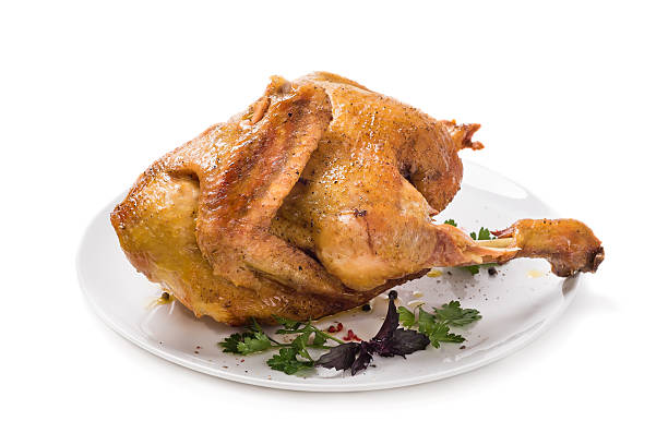 istock Baked chicken with spices isolated on white background 521076103