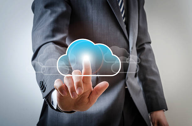 istock Business man touches a screen with a cloud symbol 521076484
