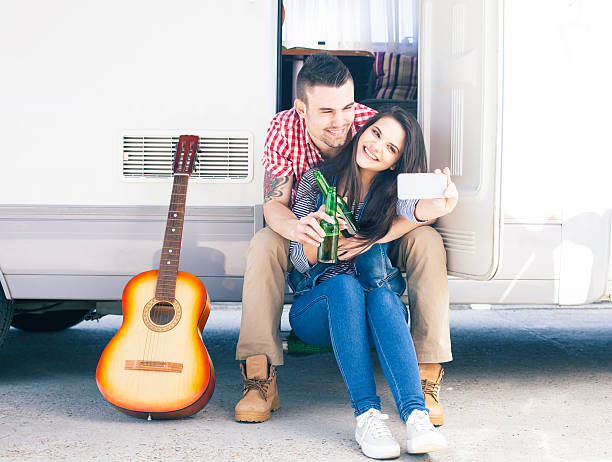 istock Young couple making selfie in front of a camper van 521077234