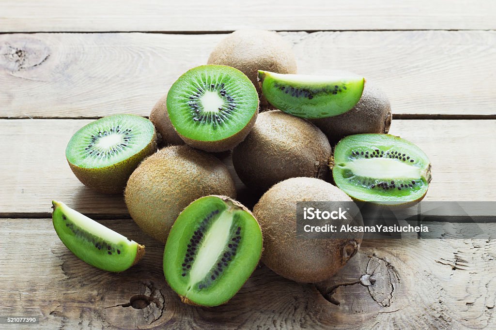 Juicy kiwi fruit on wooden background Juicy kiwi fruit on wooden dark  background Agriculture Stock Photo