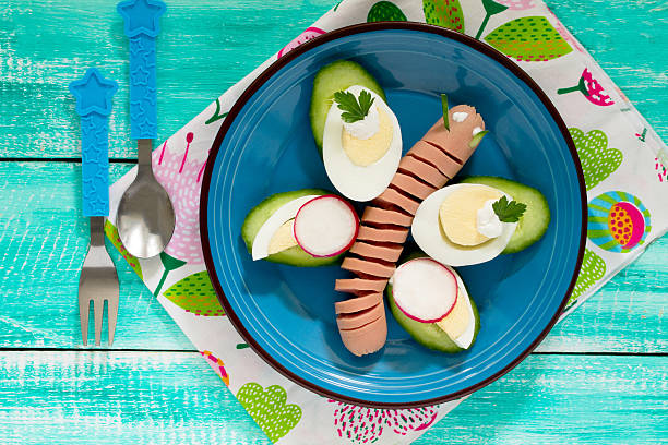istock Funny butterfly, creative breakfast for children cucumber, radis 521078278