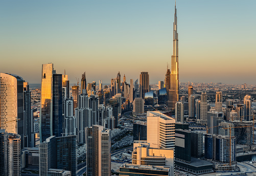 Beautiful modern city architecure at sunset. Rooftop view of Dubai's business bay towers.