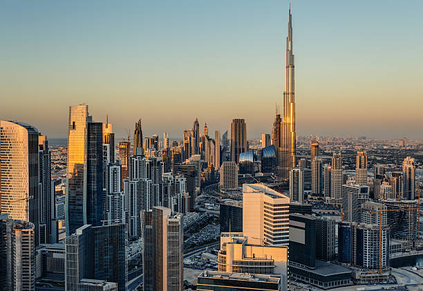 Modern architecure of Dubai, UAE, at sunset. Beautiful modern city architecure at sunset. Rooftop view of Dubai's business bay towers. khalifa stock pictures, royalty-free photos & images