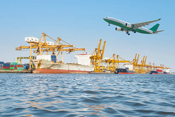 istock Airplane and Container Cargo freight ship with working crane bri 521079260