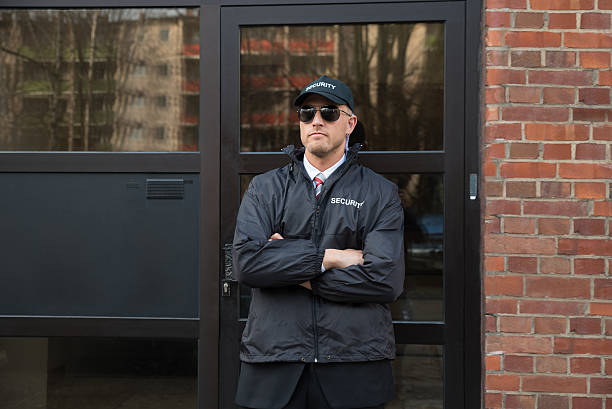 istock Security Guard Standing In Front Of The Entrance 521080806