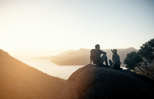 Shot of a young couple hiking the mountains in the morning