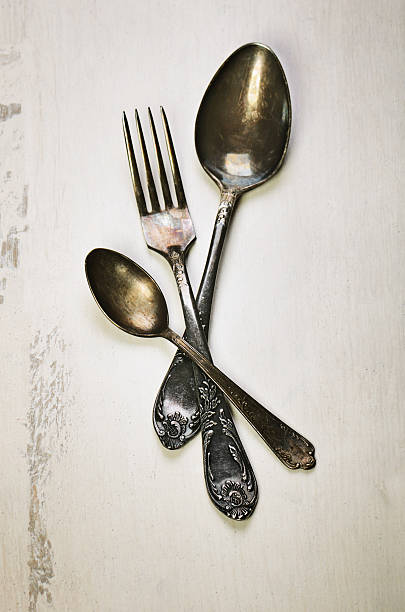 istock German silver spoon and fork on a white wooden background 521081854