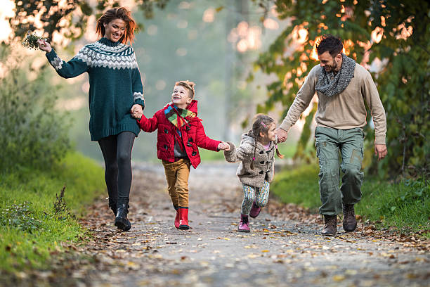 istock Young playful family having fun while running in the park. 521081958