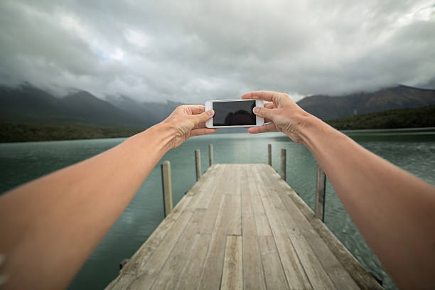 istock Personal perspective of person taking picture using mobile phone-Pier 521082280