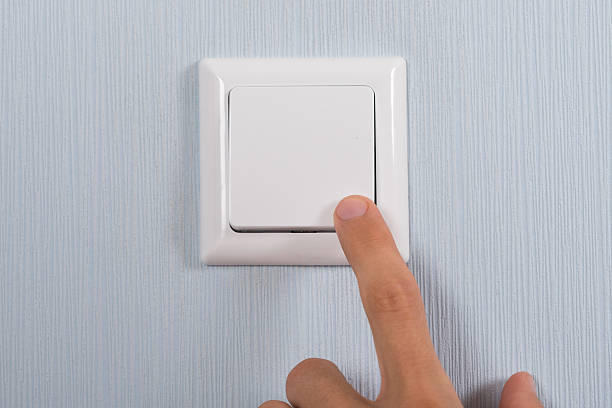 istock Close-up Of Hand Pressing Switch 521082422
