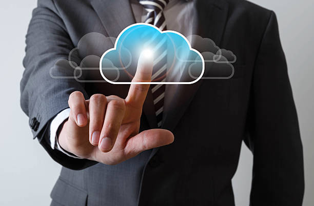 istock Business man touches a screen with a cloud symbol 521083296