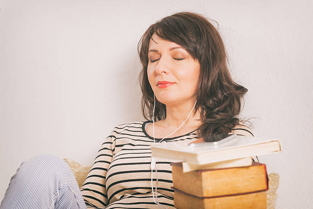 istock Woman listening an audiobook 521084080