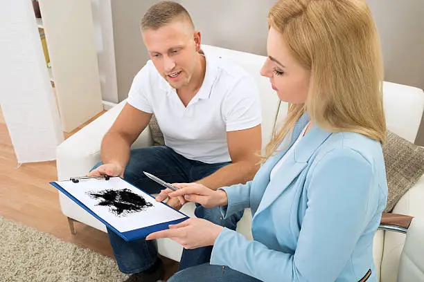 Photo of Psychologist Showing Rorschach Inkblot To Patient