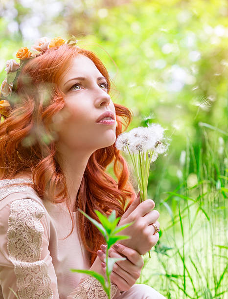 istock Dreamy woman with dandelions 521086062