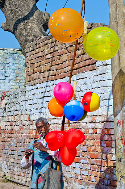 At a lively market, vibrant balloon flowers in shades of pink and blue draw the attention of passersby.