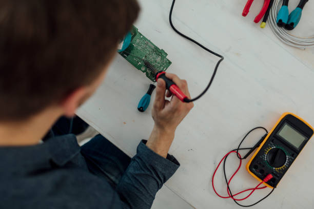 istock Man Soldering a circuit board in his tech office. 521087464