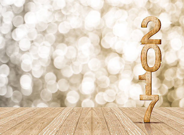 istock Year 2017 wood number in perspective room with sparkling bokeh 521087634