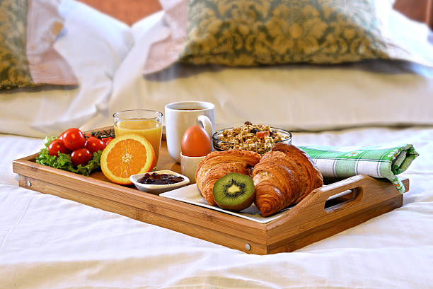 istock Breakfast tray in bed in hotel room 521088048