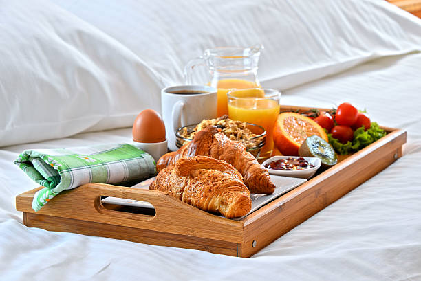 istock Breakfast tray in bed in hotel room 521088096