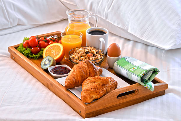 istock Breakfast tray in bed in hotel room 521088142