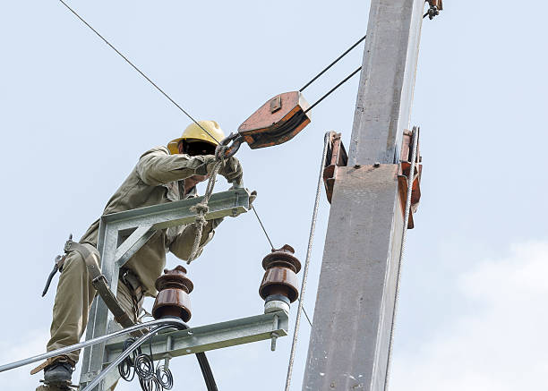 istock One electrician climbing and repairing for normal working. 521088346