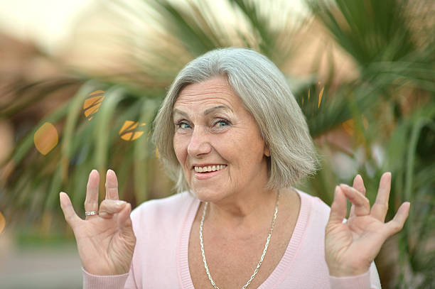 istock senior woman in summer park 521088642