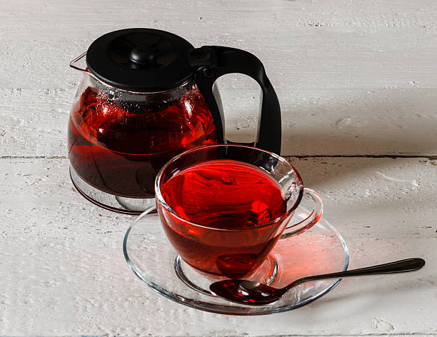 istock Cup of Karkadeh Red Tea and kettle on wooden table 521089494