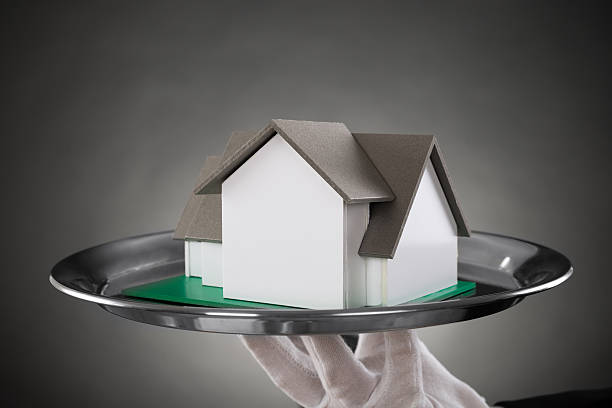 istock Close-up Of Butler With House Model 521090184