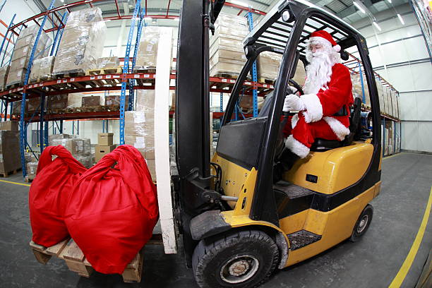 istock Santa Claus as a forklift operator at work in warehouse 521112091