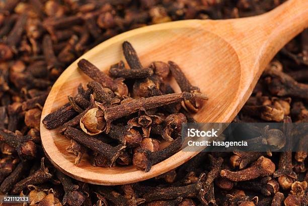 Cloves And Wooden Spoon Closeup Food Background Stock Photo - Download Image Now