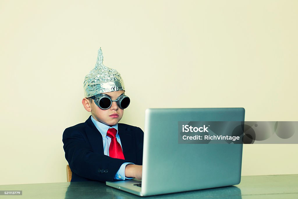 Businessman In Tune with Business A young business boy in a tinfoil hat tries everything he can think of to get in touch with his customers. Child Stock Photo