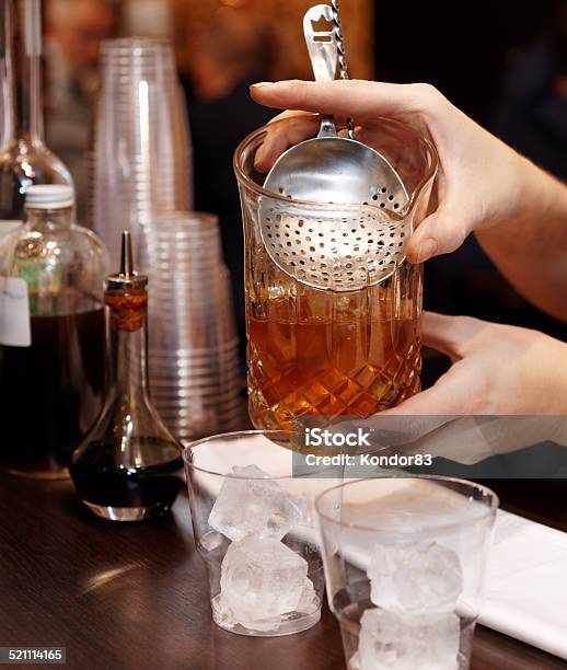 Bartender Is Straining Cocktail Into Glass Stock Photo - Download Image Now - Adult, Alcohol - Drink, Bar - Drink Establishment