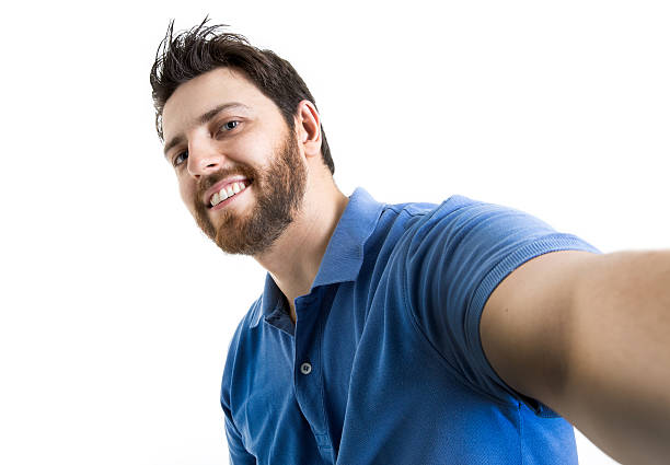 istock Happy young man taking a selfie photo on white background 521123856