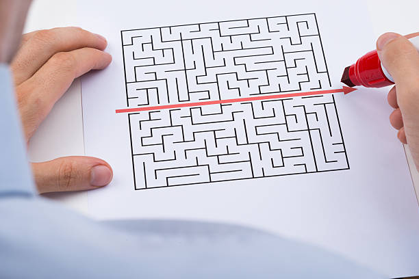 istock Person Drawing Straight Red Line Over Maze 521124086