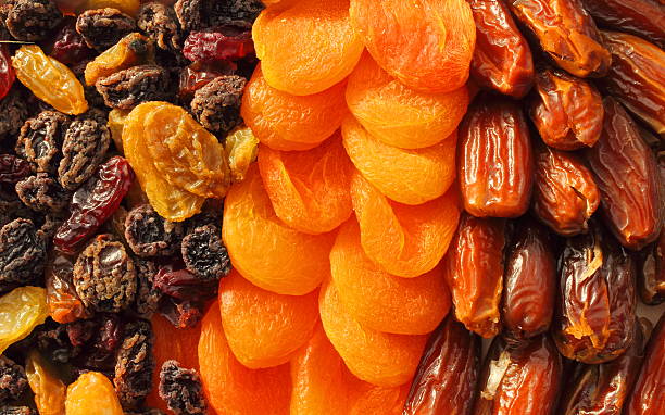 Dried fruit assortment of dates, raisins and apricots stock photo