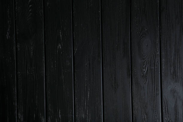 istock Black wooden background, close up 521125276