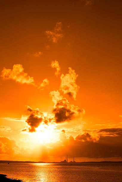 istock orange sunset over a power station 521125406