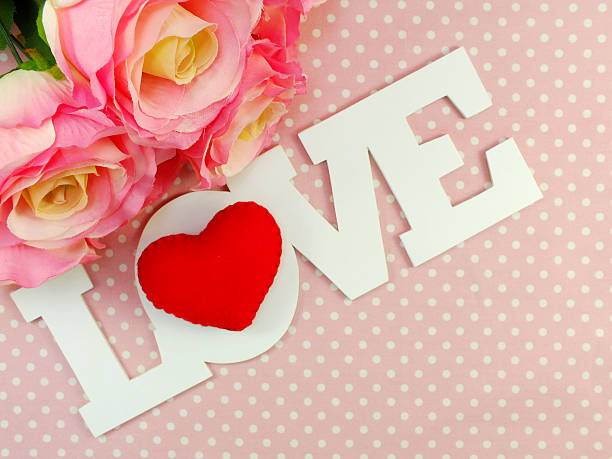 istock love word with roses and cute doll valentine dat concept 521125732