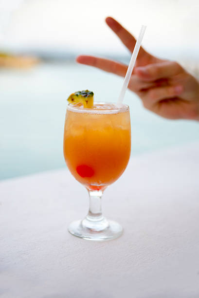 istock Tropical drink with hand gesture of peace sign 521126246
